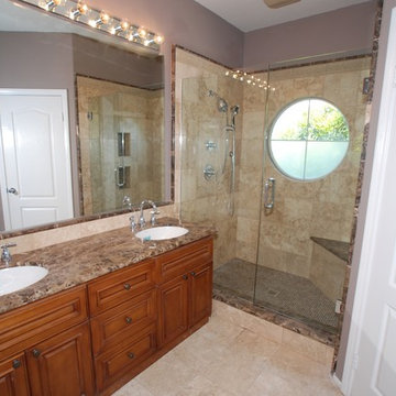 Marble and Travertine With kohler Fixtures and Round Window in Newport Coast