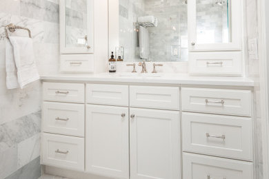 Bathroom - small traditional master gray tile and marble tile single-sink, marble floor and gray floor bathroom idea in DC Metro with shaker cabinets, white cabinets, quartz countertops, white countertops, a built-in vanity, a two-piece toilet and a hinged shower door