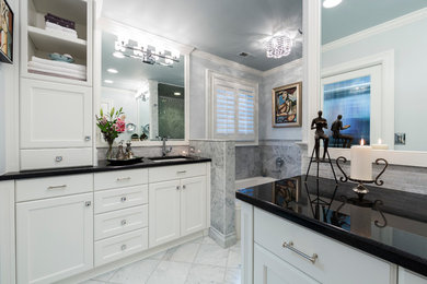 Inspiration for a mid-sized transitional master white tile and stone slab marble floor and gray floor bathroom remodel in Charlotte with an undermount sink, recessed-panel cabinets, white cabinets, granite countertops, a two-piece toilet and gray walls