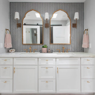 Inspiration for a mid-sized transitional master gray tile and glass tile marble floor and white floor alcove shower remodel in San Diego with recessed-panel cabinets, white cabinets, a one-piece toilet, gray walls, an undermount sink, marble countertops, a hinged shower door and white countertops