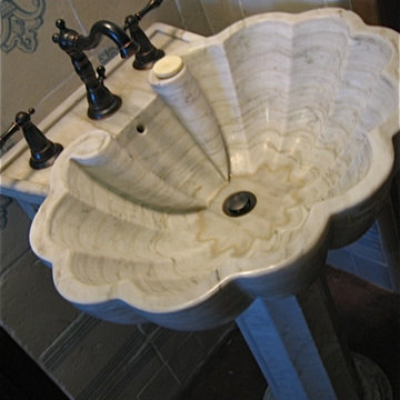 Marble pedestal sink in universal access bath with handmade tiles