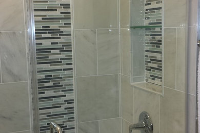 Inspiration for a small master white tile marble floor alcove shower remodel in Chicago with shaker cabinets, medium tone wood cabinets, a one-piece toilet, gray walls, an undermount sink and quartz countertops