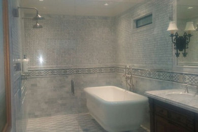 Example of a mid-sized classic master gray tile and limestone tile limestone floor and gray floor bathroom design in Santa Barbara with raised-panel cabinets, dark wood cabinets, gray walls, an undermount sink, marble countertops and a hinged shower door