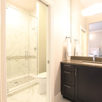 Marble Tile Floor and Walk in Shower with Herringbone Accent Tile