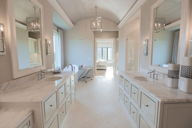 Example of a trendy master bathroom design in Kansas City with marble countertops