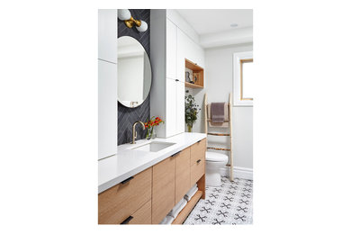 Design ideas for a contemporary ensuite bathroom in Toronto with flat-panel cabinets and solid surface worktops.
