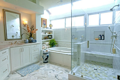 This is an example of a large traditional ensuite bathroom in Orange County with shaker cabinets, white cabinets, a built-in bath, a corner shower, white tiles, metro tiles, beige walls, marble flooring, a submerged sink, grey floors and a hinged door.