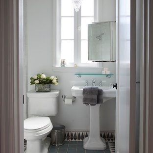 Photo of a mid-sized mediterranean bathroom in San Francisco with a pedestal sink, an alcove shower, multi-coloured tile, terra-cotta tile, white walls, terra-cotta floors, a two-piece toilet and blue floor.
