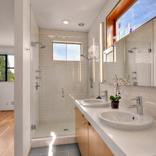 Inspiration for a modern white tile and subway tile gray floor alcove shower remodel in Seattle with a drop-in sink, flat-panel cabinets and medium tone wood cabinets