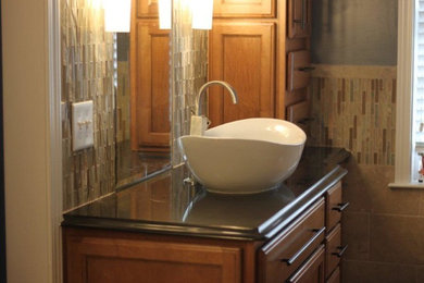 Example of a mid-sized transitional master multicolored tile and ceramic tile bathroom design in Charlotte with raised-panel cabinets, medium tone wood cabinets and quartzite countertops