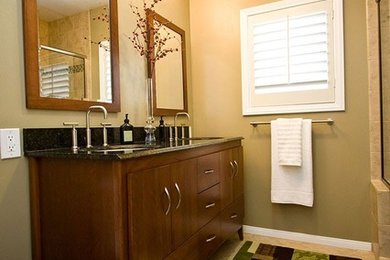 Mid-sized transitional master beige tile and ceramic tile ceramic tile and beige floor bathroom photo in Boston with flat-panel cabinets, dark wood cabinets, a two-piece toilet, beige walls, an undermount sink, granite countertops and a hinged shower door