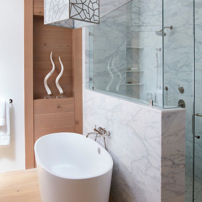 Mid-sized trendy master gray tile, white tile and marble tile medium tone wood floor and brown floor bathroom photo in San Francisco with white walls, a hinged shower door, flat-panel cabinets, medium tone wood cabinets, a two-piece toilet, an undermount sink and marble countertops