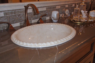 Example of a classic bathroom design in Other with a drop-in sink and marble countertops