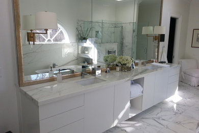 Minimalist white tile bathroom photo in St Louis with flat-panel cabinets, white cabinets and marble countertops