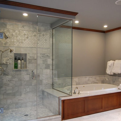 Example of a large classic master gray tile and stone tile marble floor bathroom design in Portland with an undermount sink, shaker cabinets, medium tone wood cabinets, marble countertops, a wall-mount toilet, gray walls, a hinged shower door and gray countertops