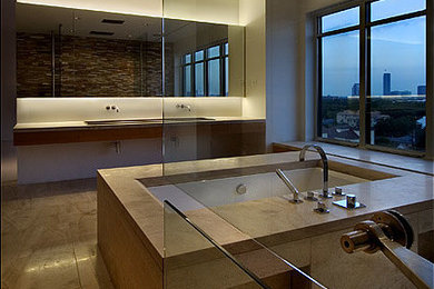 Modelo de cuarto de baño principal moderno con armarios abiertos, bañera encastrada sin remate, ducha abierta, sanitario de una pieza y suelo de piedra caliza