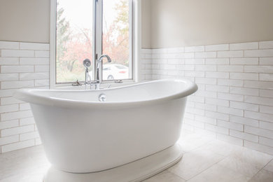Inspiration for a master subway tile porcelain tile freestanding bathtub remodel in Chicago
