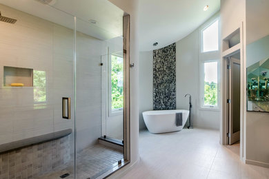 Example of a large minimalist master multicolored tile and porcelain tile porcelain tile and multicolored floor bathroom design in Other with flat-panel cabinets, light wood cabinets, gray walls, quartz countertops and a hinged shower door
