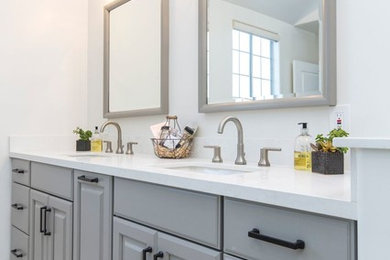 Example of a mid-sized trendy master gray floor bathroom design in Los Angeles with raised-panel cabinets, gray cabinets, gray walls, an undermount sink, quartz countertops and white countertops