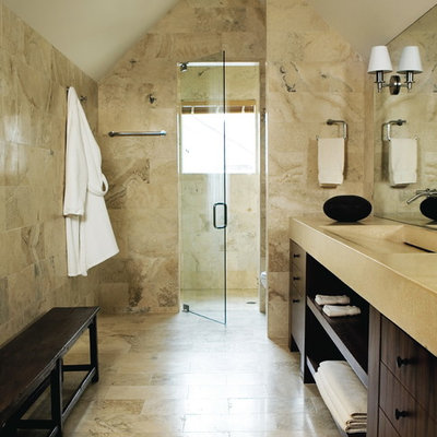 Example of a trendy beige tile and limestone tile alcove shower design in Atlanta with open cabinets, dark wood cabinets and an integrated sink