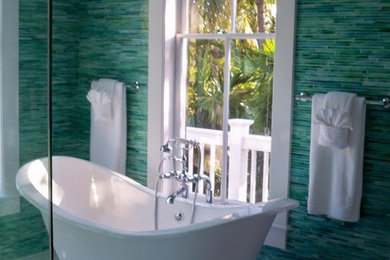 Example of a large island style master glass tile, blue tile and green tile porcelain tile bathroom design in Miami with green walls