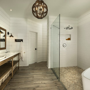 This is an example of a large arts and crafts master bathroom in Atlanta with open cabinets, light wood cabinets, a freestanding tub, a curbless shower, multi-coloured tile, mosaic tile, white walls, porcelain floors, a drop-in sink and engineered quartz benchtops.