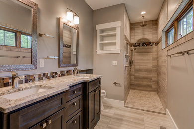 Bathroom - mid-sized contemporary master brown tile and glass tile slate floor and beige floor bathroom idea in Other with dark wood cabinets, a one-piece toilet, beige walls, an undermount sink, granite countertops and recessed-panel cabinets