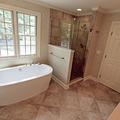 Example of a mid-sized classic master beige tile and stone tile ceramic tile bathroom design in Cleveland with an undermount sink, raised-panel cabinets, white cabinets, quartz countertops, a two-piece toilet and green walls