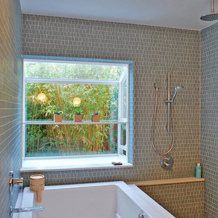 Inspiration for a contemporary bathroom in San Francisco with a japanese tub, green tile and mosaic tile.