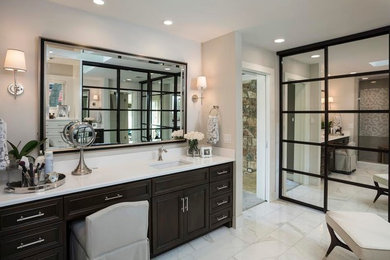 Large trendy master marble floor bathroom photo in Austin with recessed-panel cabinets, black cabinets, beige walls and an undermount sink