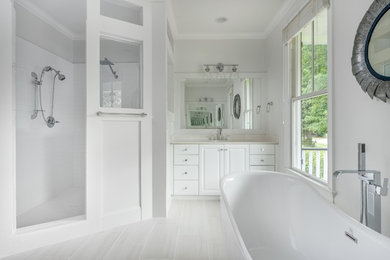 Inspiration for a large modern master white tile and porcelain tile porcelain tile and white floor bathroom remodel in Charleston with raised-panel cabinets, white cabinets, a one-piece toilet, white walls, a drop-in sink, quartz countertops, a hinged shower door and white countertops