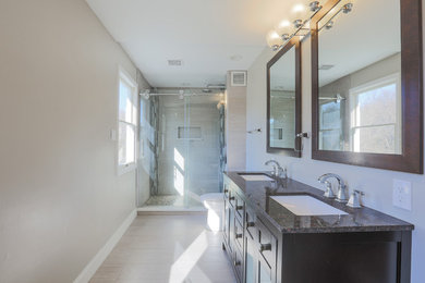 Inspiration for a mid-sized transitional master porcelain tile and beige floor bathroom remodel in Baltimore with beige walls, furniture-like cabinets, dark wood cabinets, a two-piece toilet, an undermount sink and granite countertops