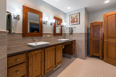 Design ideas for an expansive classic ensuite bathroom in Milwaukee with raised-panel cabinets, medium wood cabinets, a built-in shower, a one-piece toilet, grey tiles, ceramic tiles, blue walls, ceramic flooring, a vessel sink, quartz worktops, white floors, an open shower and grey worktops.