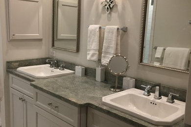 Example of a small transitional white tile and ceramic tile porcelain tile alcove shower design in Other with recessed-panel cabinets, gray cabinets, a two-piece toilet, gray walls, a drop-in sink and granite countertops