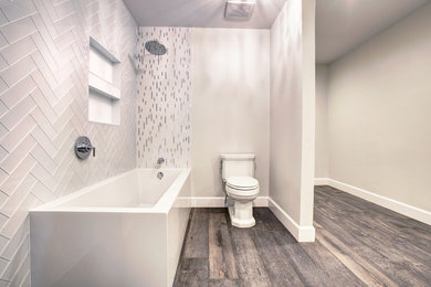 Example of a large trendy master gray tile, white tile and porcelain tile dark wood floor and gray floor bathroom design in Houston with a two-piece toilet and gray walls