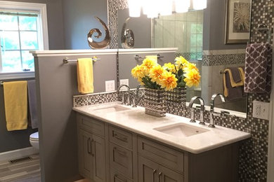 Mid-sized transitional master gray tile and mosaic tile ceramic tile bathroom photo in Other with an undermount sink, gray cabinets, marble countertops, gray walls, shaker cabinets and a two-piece toilet