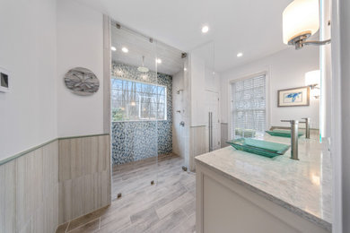 Example of a large transitional master multicolored tile and ceramic tile multicolored floor double shower design in Bridgeport with shaker cabinets, white cabinets, white walls, a vessel sink, quartz countertops, a hinged shower door and multicolored countertops