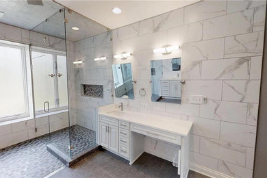 Example of a large minimalist master multicolored tile and marble tile porcelain tile and black floor wet room design in Indianapolis with raised-panel cabinets, white cabinets, a two-piece toilet, an undermount sink, granite countertops and white countertops