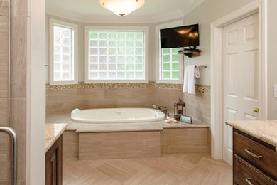 Bathroom - large contemporary master beige floor bathroom idea in Other with raised-panel cabinets, brown cabinets, gray walls, an undermount sink, granite countertops and a hinged shower door