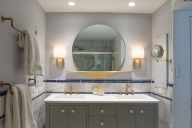 Example of a transitional gray tile and marble tile marble floor and gray floor bathroom design in Philadelphia with furniture-like cabinets, gray cabinets, a two-piece toilet, gray walls, an undermount sink, quartz countertops and white countertops