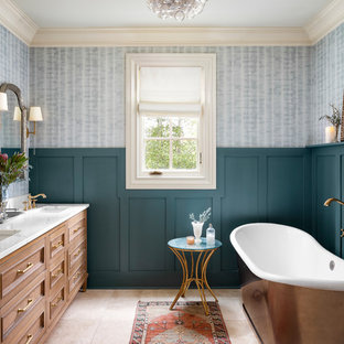 Example of a classic ceramic tile and beige floor freestanding bathtub design in Atlanta with furniture-like cabinets, light wood cabinets, an undermount sink, quartz countertops and white countertops