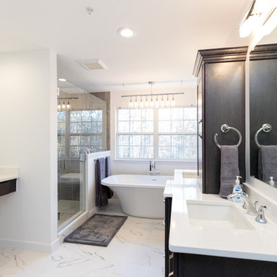 Inspiration for a mid-sized contemporary master gray tile and porcelain tile marble floor bathroom remodel in DC Metro with white walls, an undermount sink, a hinged shower door, quartz countertops, shaker cabinets, dark wood cabinets and a two-piece toilet