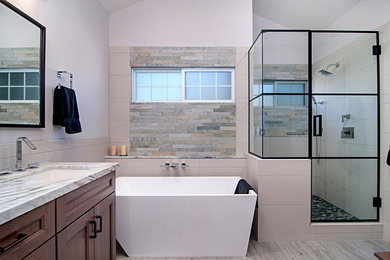 Example of a mid-sized minimalist master beige tile and porcelain tile porcelain tile and gray floor bathroom design in San Diego with shaker cabinets, medium tone wood cabinets, a one-piece toilet, purple walls, an undermount sink, quartzite countertops and a hinged shower door