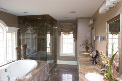 Large elegant beige tile marble floor bathroom photo in New York with an undermount sink, beaded inset cabinets, distressed cabinets, granite countertops, a one-piece toilet and beige walls