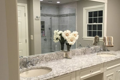 Example of a mid-sized transitional master gray tile and porcelain tile porcelain tile alcove shower design in Boston with raised-panel cabinets, white cabinets, an undermount sink and quartz countertops