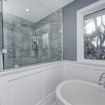 Master bath shower enclosure and wainscot paneling around tub area.