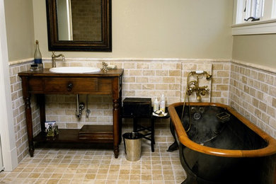 ボルチモアにある中くらいなトラディショナルスタイルのおしゃれなバスルーム (浴槽なし) (オーバーカウンターシンク、濃色木目調キャビネット、置き型浴槽、ベージュのタイル、サブウェイタイル、シャワー付き浴槽	、分離型トイレ、ベージュの壁、ライムストーンの床、木製洗面台、ブラウンの洗面カウンター、フラットパネル扉のキャビネット) の写真