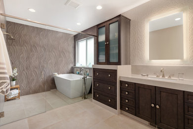 Inspiration for a large contemporary master brown tile and porcelain tile porcelain tile and beige floor bathroom remodel in Seattle with brown cabinets, a one-piece toilet, brown walls, an undermount sink, quartz countertops, a hinged shower door and beige countertops