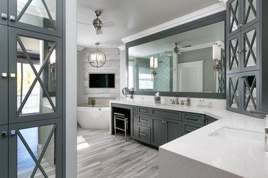 Inspiration for a mid-sized transitional master gray tile and porcelain tile porcelain tile and gray floor bathroom remodel in San Diego with shaker cabinets, gray cabinets, a one-piece toilet, gray walls, an undermount sink, quartz countertops, a hinged shower door and white countertops