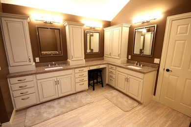 Mid-sized trendy master ceramic tile and beige tile ceramic tile bathroom photo in Other with quartzite countertops, raised-panel cabinets, white cabinets, brown walls and an undermount sink